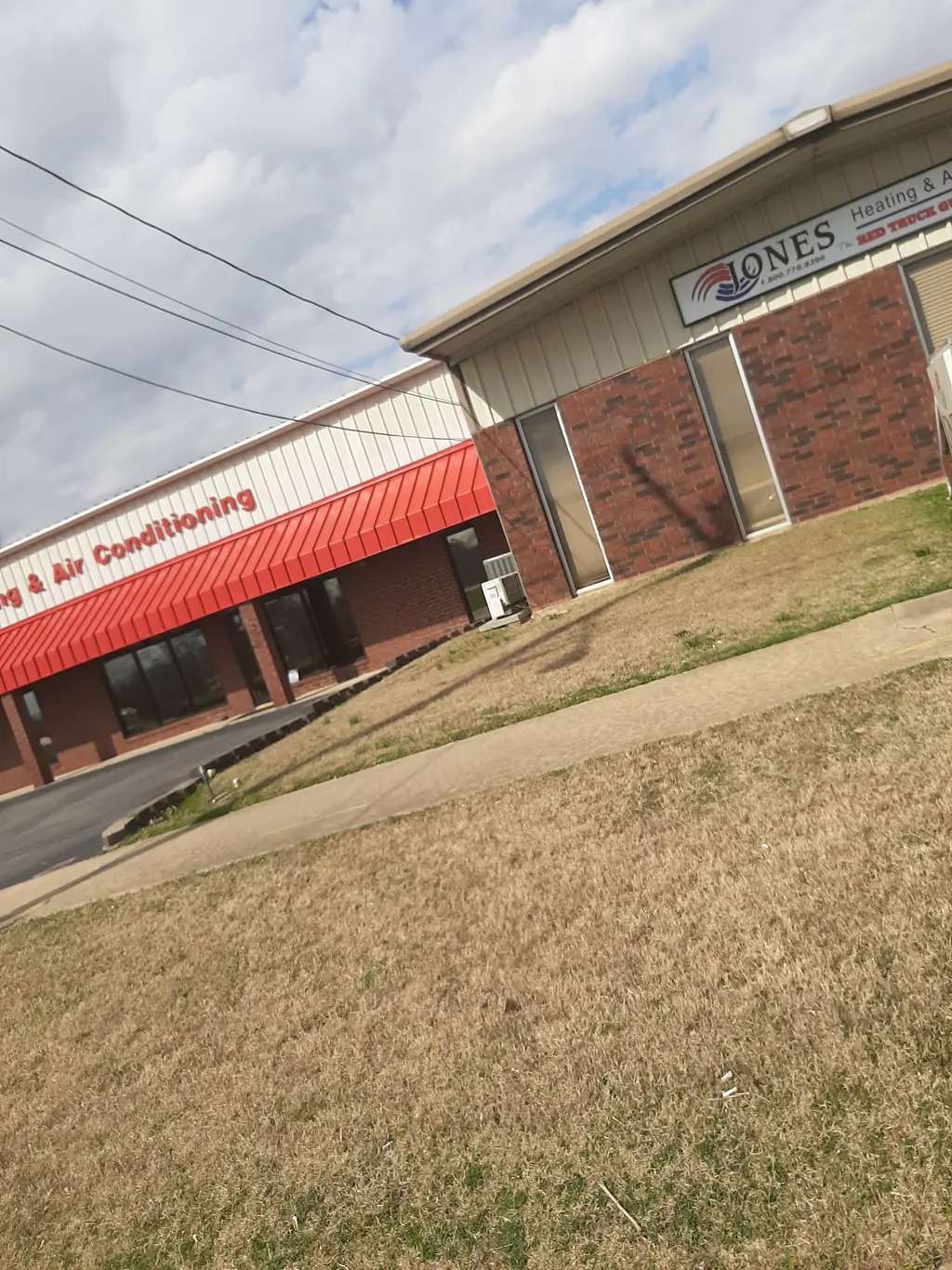 The Jones Heating & Air premises signage carrying the Red Truck Guys line above the service entrance